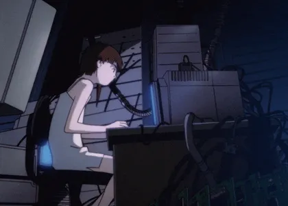 Lain at her computer in a room full of cables